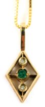 A 9ct gold emerald and diamond pendant and chain, the diamond shaped pendant set with central emeral