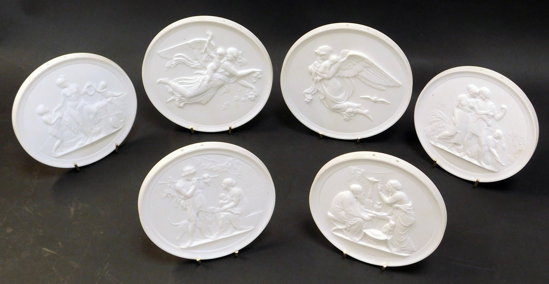 A set of six Royal Copenhagen matt porcelain plaques, depicting the four seasons and day and night,