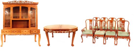 An Oriental cherry wood dining suite, comprising extending table with two additional leaves with fru