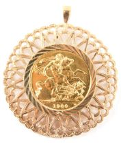 An Elizabeth II full gold sovereign and pendant, dated 1980, with fan design circular pendant, yello