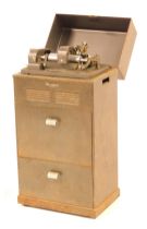 A Dictaphone model S12, serial number 90744, in original steel housing and with two drawers below.