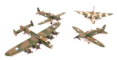 Four wooden scratch built models of World War II fighter planes, a Bomber, and a Vulcan jet fighter.