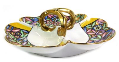 A Limoges porcelain hors d'ouevres dish, of three sectional form with shell capped border, with a gi