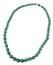 A jadeite graduated necklace, with spherical beads on a knotted string stand, with a gold coloured c