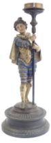 A late 19thC Continental cold painted spelter figure candlestick, cast as a Medieval gentleman, on a