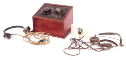 A vintage crystal radio set, with headphones, mahogany cased, together with an Ivalek Deluxe crystal