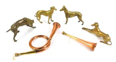 Four brass model dogs, together with a copper and brass hunting horn, of twisted design, 52cm long,