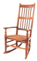 A 19thC rush seated open armchair, the high back with bobbin turned spindles, and with turned suppor