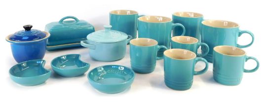 A group of Le Creuset homewares, comprising a set of four 0.35 litre light blue mugs, four 0.1 litre