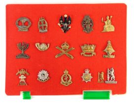 A group of military cap badges, to include Royal Army Medical Corps, Machine Gun Corps, The Kings Ro