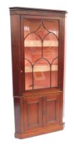 A 19thC mahogany standing corner display cabinet, the top with a fluted frieze, above an astragal gl