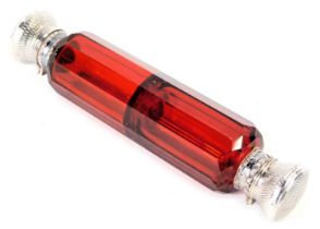A Victorian cranberry glass double ended scent bottle, the white metal ends with engine engraved flo
