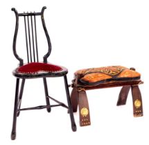 An early 20thC ebonised single chair, with lyre back and heart shaped padded seat, and a North Afric