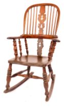A 19thC burr, ash and elm Windsor rocking chair, with a pierced Christmas tree splat, on moulded