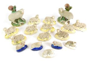 A group of 19thC Staffordshire pottery figures of ewes and rams, including a pair of spill vases, an