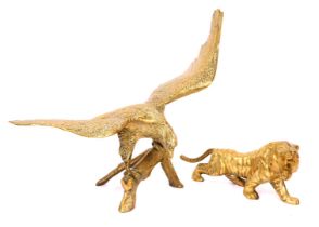 Two brass animals, comprising a brass tiger, 39cm long, and an eagle on perch, 54cm high, 58cm wide.