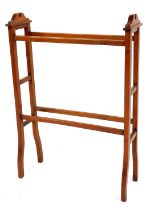 A walnut towel rail, with arched stiles, 90cm high, 60cm wide, 22cm deep.