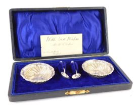 A pair of Edward VII silver open salts, embossed with spiral fluting, with spoons, cased, Birmingham