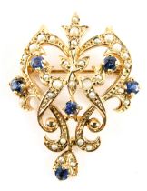 A 9ct gold Art Nouveau pendant/brooch, set with seed pearls and sapphires, of scroll design with pen