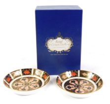 A pair of Royal Crown Derby Imari porcelain circular spoon dishes, pattern 1128, together with an Im