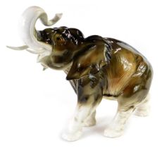 A Royal Dux porcelain figure, modelled as an elephant with raised trunk, printed marks, 33cm high.