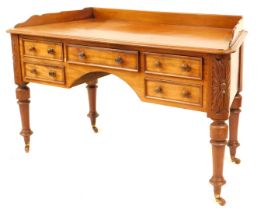 A Victorian mahogany dressing table, with canted sides, having shaped low gallery back and with thum