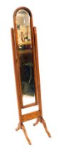 A 20thC oak framed cheval mirror, of slender design with an arched top, 180cm high, 36cm wide, 52cm