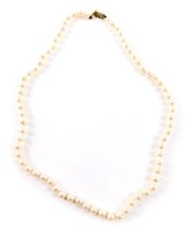 A single strand cultured pearl necklace, with white lustre finish beads, on a knotted string strand