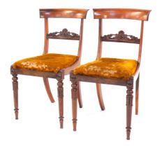 A pair of William IV rosewood dining chairs, with plain curved cresting rails and carved horizontal