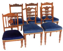 A set of six Edwardian dining chairs, with carved cresting rails and pierced and carved splats, over