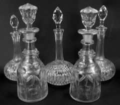 Five pressed and moulded glass decanters, comprising three squat decanters and two bottle decanters.