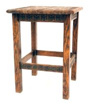 A 1920s carved oak table, the square top with cross and tulip design, 40cm high, the top 30cm x 30cm