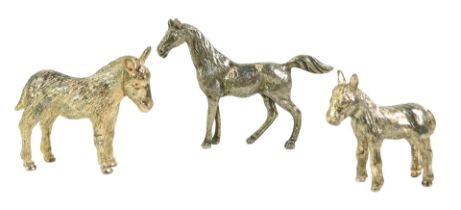 Three silver plated animals, comprising two donkeys and a horse, the horse 8cm high, the donkeys 7cm