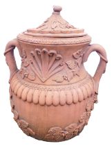 A terracotta garden two handled jar and cover, circular form decorated in relief with grapes, vines,