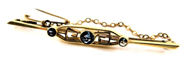 An Art Deco blue zircon set bar brooch, with Greek key design, on single pin back with safety chain,