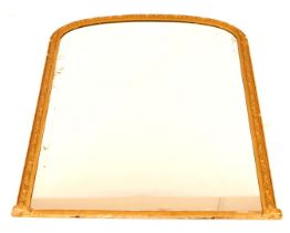 A 19thC gilt framed overmantel mirror, with an arched top and ornate gesso frame, 132cm x 106cm.