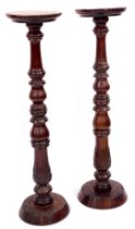 A pair of mahogany torcheres, each with turned columns, on a carved and leaf moulded base, 100cm hig