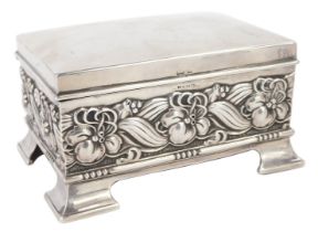 An Edward VII silver playing card box, embossed with a band of flowers and scrolling leaves, raised