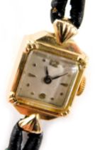 A 9ct gold cased lady's cocktail watch, with a square dial with silvered backing and black hands, 1c