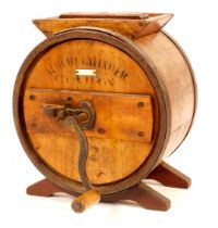 An Albert Slinger tabletop butter churn, of pine and beech, with iron straps and handle, bears label