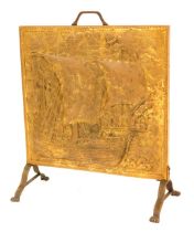 A 20thC brass fire screen, with embossed design of a gallon, on claw feet, 62cm high, 51cm wide, 22c