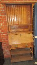 An early 20thC oak bureau bookcase, the top with a single shelf, the base with a fall above a drawer