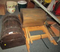 Two domed caskets, together with a folding table and chair. (4)