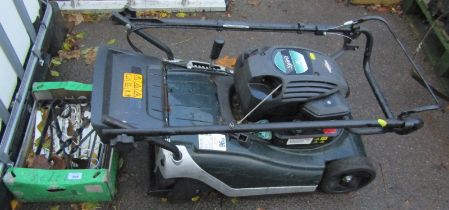 A Briggs and Stratton Spirit 41 petrol lawn mower, together with a quantity of wall brackets.
