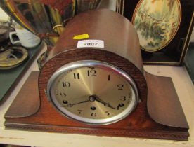 An oak Napoleon's hat mantel clock, with silvered numeric dial and thirty hour movement on a reeded