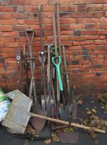 A group of garden tools, to include spades, together with mallets, spirit levels, etc.