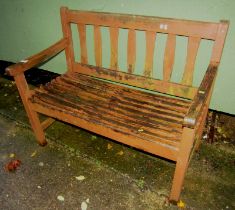 A garden bench, with slatted seat and back.