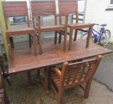 A teak garden table, together with four chairs. (5)