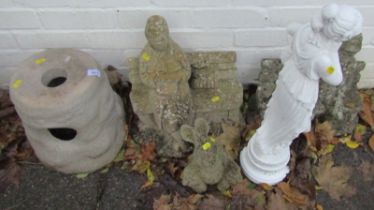 A group of garden statues, to include a pair of figures seated on benches, etc. (a quantity)