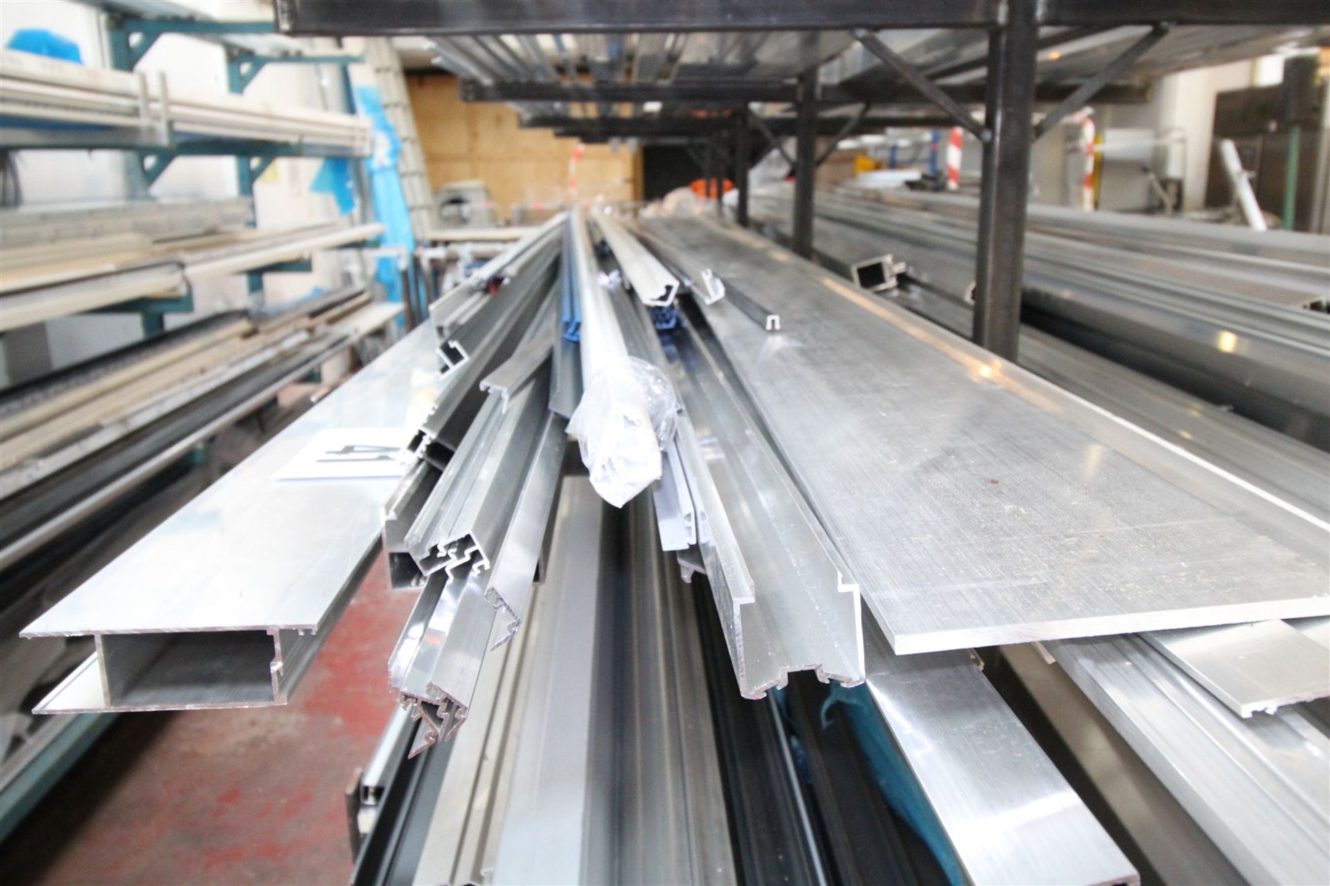 CONTENTS OF 28INCH WIDE SHELF OF RACK OF 5M LONG & SHORTER ALUMINIUM STRIP & EXTRUSION.